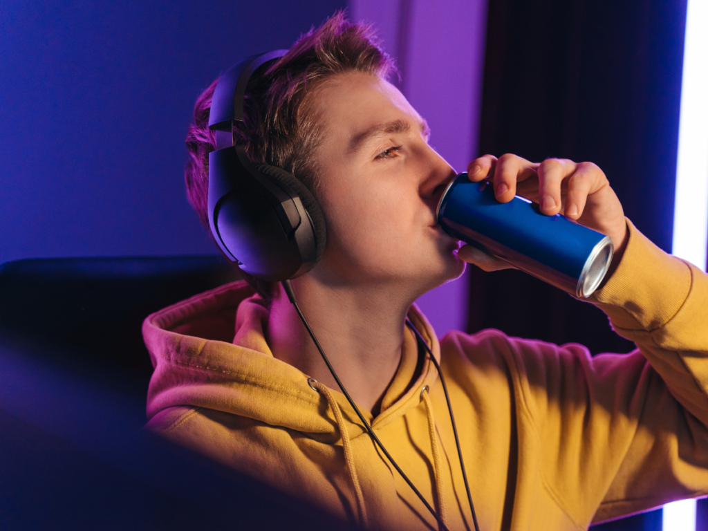 Teen drinking caffeine energy drink